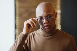 Porträt von ein ernst afrikanisch amerikanisch Mann mit Brille. foto