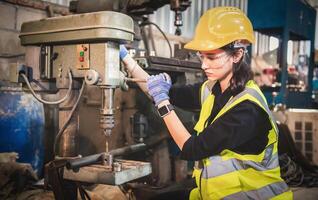 Porträt von schwer Industrie Arbeitskräfte Arbeiten auf das Metall Herstellung Prozess durch Betriebs ein Bohren beim ein Maschine zum Stahl Struktur Industrie. foto