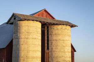 Detail von alt, verwittert, rot Scheune mit Zwilling Silos im Sonnenuntergang Licht beim Colorado Ausläufer foto