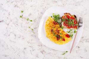 Omelette mit Käse und Toast mit Tomaten auf Weiß Platte. Frittata - - Italienisch Omelett. oben Sicht, eben legen foto