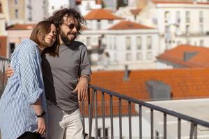 Paar im Liebe umarmen während Stehen auf alt Stadt Aussicht mit uralt die Architektur Hintergrund foto