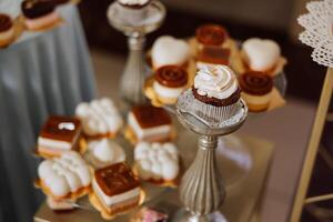 Mandel Kekse, Süss Kuchen zum ein Hochzeit Bankett. ein köstlich Rezeption, ein luxuriös Zeremonie. Tabelle mit Süßigkeiten und Nachspeisen. köstlich bunt Französisch Nachspeisen auf ein Teller oder Tisch. Süßigkeiten Bar. foto