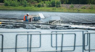 beide von Techniker sind zur Zeit auswerten und reparieren das Getriebe Terminals zum Elektrizität generiert durch Solar- Energie im ein schwebend Solar- Leistung System. foto