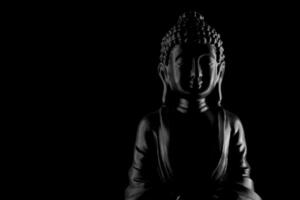 Buddha Purnima und vesak Tag Konzept, grau Buddha Statue mit niedrig Schlüssel Licht gegen tief schwarz Hintergrund foto