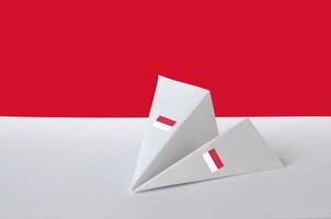 Monaco Flagge abgebildet auf Papier Origami Flugzeug. handgemacht Kunst Konzept foto