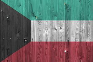 Kuwait Flagge abgebildet im hell Farbe Farben auf alt hölzern Mauer. texturiert Banner auf Rau Hintergrund foto