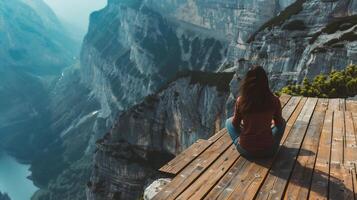 ai generiert jung Frau Sitzung auf das Kante von ein Cliff und genießen das Aussicht foto