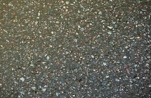 Oberfläche Grunge Rau von Asphalt. Asphalt dunkel grau körnig Straße. Textur Hintergrund oben Aussicht foto