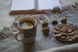 ein Tasse von Tee mit Zitrone und Kuchen. Hygge eben legen. foto