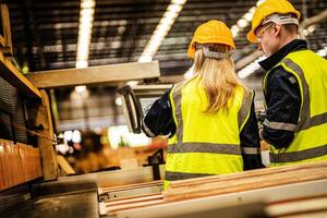 zurück von Fabrik Ingenieur Arbeitskräfte Stehen zu Steuerung Panel schalten. Menschen funktioniert beim schwer Maschine beim Industrie Fabrik. mit Maschinen Ausrüstung Pflanze Technologie. Clever Industrie Arbeiter Betriebs. foto