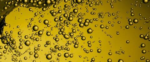 golden Hyaluron Öl Luftblasen Kollagen Serum oder Gelb Öl Luftblasen fallen Textur Hintergrund foto
