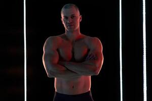 aktiv Lebensstil Konzept. Fachmann Bodybuilder zeigen perfekt muskulös Körper, Lampen Erleuchtung auf Hintergrund foto