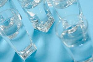Brille mit Wasser auf Blau Hintergrund. sauber Wasser Konzept foto