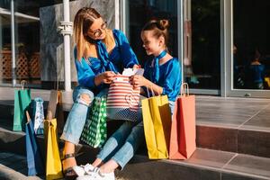 Verkauf, Konsumismus und Menschen Konzept - - glücklich jung Frauen ihr dauther mit Einkaufen Taschen Gehen Stadt Straße foto