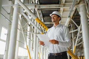 glücklich männlich industriell Techniker Innerhalb ein Fabrik foto