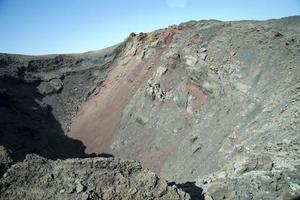 Vulkanberg mit rotem Sand und Felsen. Lanzarote, Kanarische Inseln, Spanien. foto