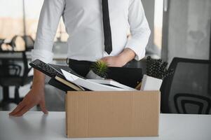 Nahansicht von ein Geschäftsperson Tragen Karton Box während Büro Treffen foto