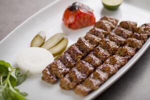 Fleisch suche Kebab serviert im Gericht isoliert auf grau Hintergrund oben Aussicht von Arabisch Essen foto