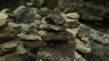 Nahansicht von gestapelt Türme von Steine. Clip. Berg Steine wurden gestapelt im Türme. gestapelt Türme von Felsen auf Hintergrund von Felsen foto