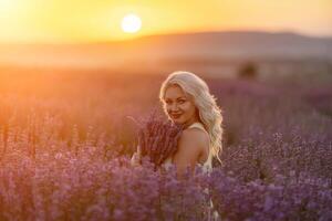 blond Frau posiert im Lavendel Feld beim Sonnenuntergang. glücklich Frau im Weiß Kleid hält Lavendel Strauß. Aromatherapie Konzept, Lavendel Öl, Foto Session im Lavendel