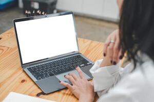 Nahansicht zurück Aussicht von ein Geschäft Frau Arbeiten im das Büro tippen, suchen beim das Bildschirm. Büro Arbeiter mit ein Notizbuch Computer. foto