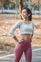 passen jung Frau genießen ein brechen während ihr Übung Routine im ein Park, reflektieren Positivität und Widmung zu physisch Gesundheit. foto