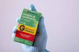 rio, brasilien - 27. januar 2023, hand mit schützendem gummihandschuh, der medikamentenbox hält, cipofloxacinhydrochlorid foto