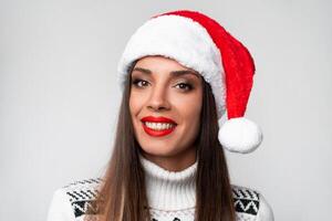 schließen oben Porträt wunderschön kaukasisch Frau im rot Santa Hut auf Weiß Studio Hintergrund. Weihnachten und Neu Jahr Urlaub Konzept. foto