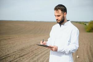 Boden testen. Agronomie Spezialist nehmen Boden Stichprobe zum Fruchtbarkeit Analyse. Hände im Handschuhe schließen hoch. Umwelt Schutz, organisch Boden Zertifizierung, Feld arbeiten, Forschung. foto