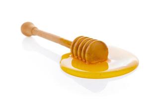 Honiglöffel aus Holz mit Honig foto