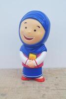 Foto Porträt von ein süß Lächeln von ein Spielzeug Muslim Mädchen