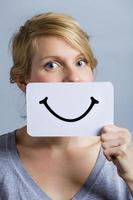 glückliches Porträt von jemandem, der ein lächelndes Moodboard hält foto