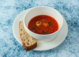 Tomate Suppe mit Brot serviert im Teller isoliert auf Hintergrund oben Aussicht von Italienisch Essen foto