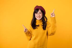 ein elegant Frau im ihr 30er Jahre, anziehen ein rot Baskenmütze und Brille, ausstrahlen Glück und zeigen ihr Finger zu kostenlos Kopieren Raum gegen ein beschwingt Gelb Hintergrund. foto