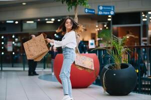 Einkaufen Zeit, Teenager Mädchen mit Einkaufen Taschen beim Einkaufen Einkaufszentrum. Einkaufen Konzept. foto