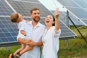 glücklich Familie in der Nähe von Solar- Tafeln. Alternative Energie Quelle foto