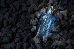 Parfüm Blau transparent Flasche im Kies oder Koralle Hintergrund foto