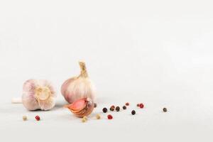 Knoblauch und Pfefferkörner auf ein Licht Hintergrund. Zutaten zum Grill. Exemplar. foto