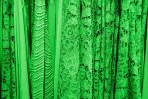 Grün Sommer- Blusen auf ein Aufhänger im das speichern, hell Sommer- Kleider foto