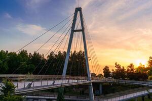 modern Steg über das anhor Kanal im navruz Park beim Sonnenuntergang im Sommer, Usbekistan, Taschkent. foto