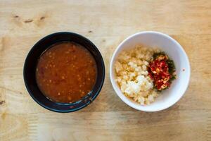 Sukiyaki Eintauchen Soße mit gehackt Knoblauch und Chili im schwarz Schüssel foto