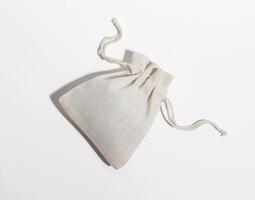 klein Textil- Baumwolle Tasche, Leinen- Sack mit Saiten Lügen auf Tabelle foto