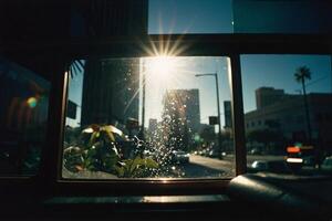 ein Aussicht von das Sonne durch ein Fenster im ein Stadt foto