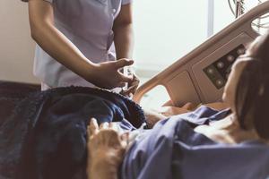 Krankenschwester, die einem Patienten im Krankenhaus eine Spritze gibt. foto