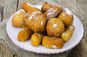 süße Quark Donuts Brötchen mit Puderzucker auf Holztisch foto