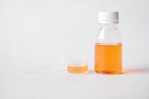 flüssige Medizin in einem Behälter auf weißem Hintergrund foto