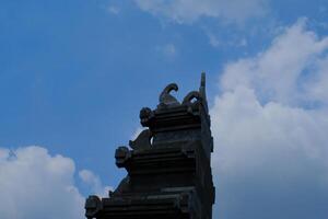 architektonisch Fotografie. architektonisch Schönheit. Aussicht von das Tor mit ein typisch balinesisch architektonisch Stil. Tor mit Aussicht von wolkig Blau Himmel. Bandung, Indonesien foto