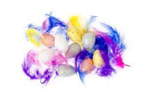 dekorative farbige Eier und Federn auf weißem Hintergrund foto