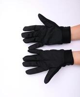 schwarz Stoff Palme Handschuhe mit Anti-Rutsch Griff, isoliert auf Weiß Hintergrund. foto