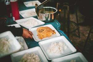 Freiwillige geben Essen zu das arm, Teilen kostenlos Essen zu Hilfe Bettler. Essen Spende Konzept foto